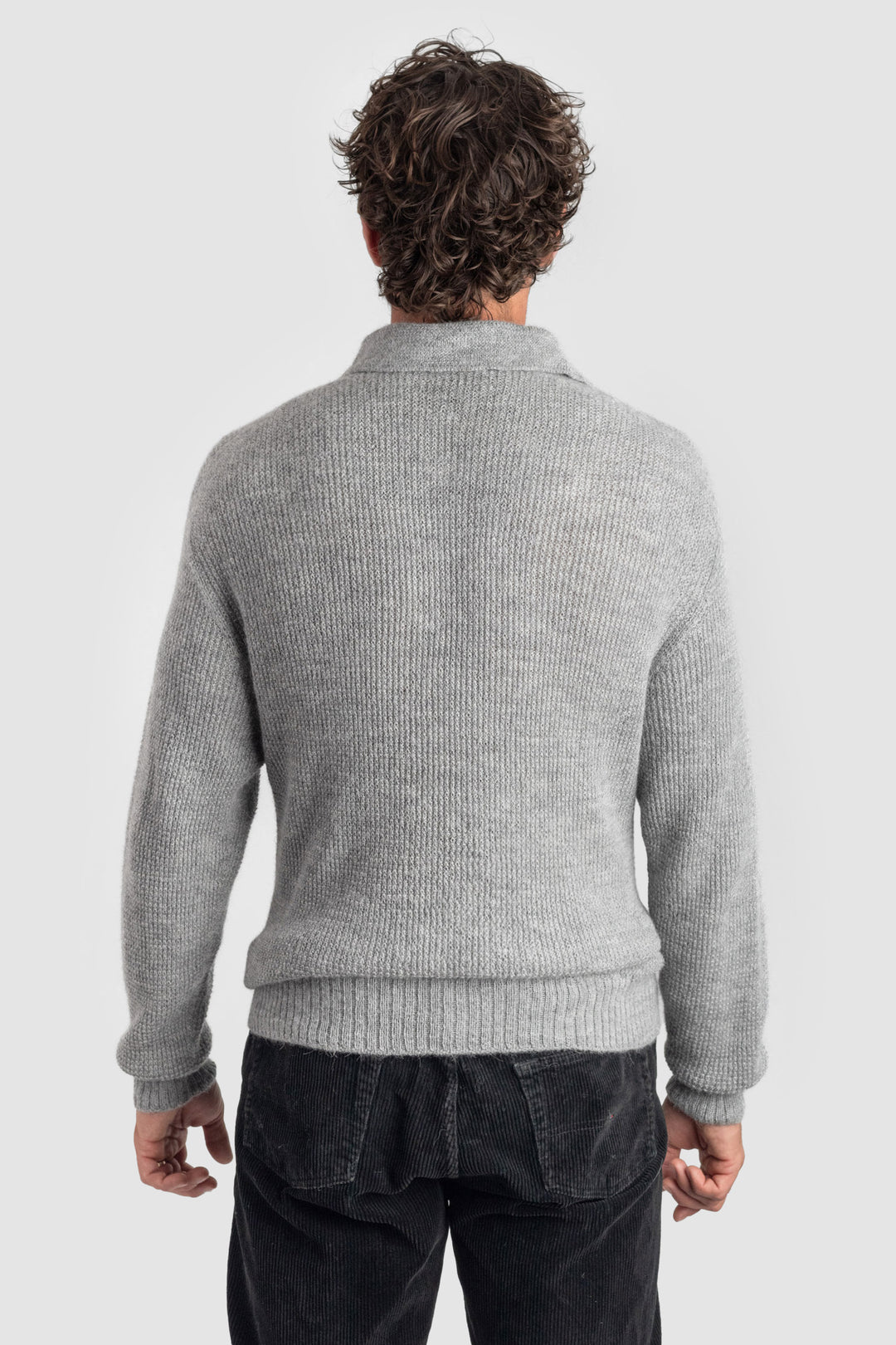 Person wearing a gray sweater on a white background #colour_cool-grey